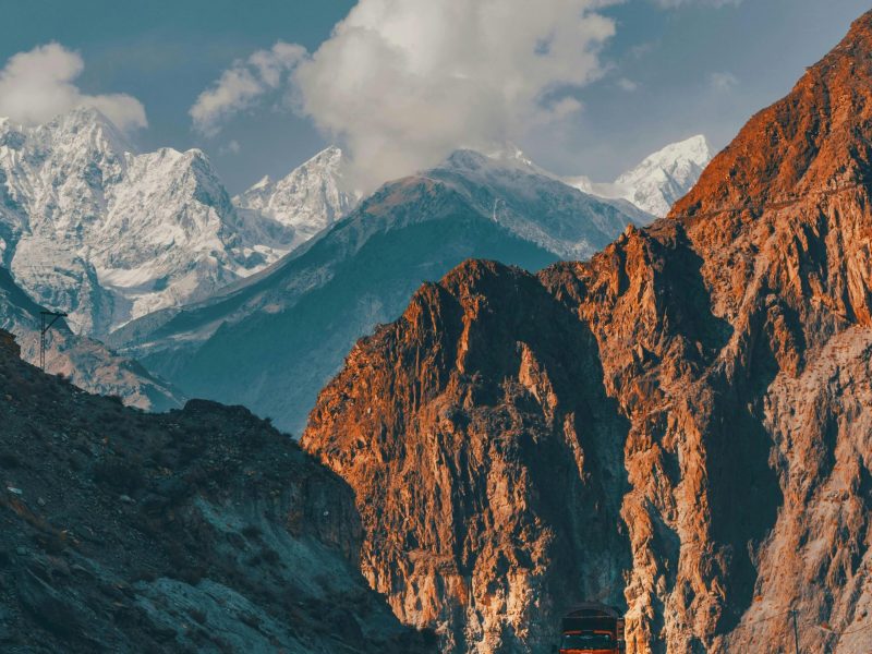 Scenic view of a mountain road with a truck in the Karakoram Range, Pakistan.